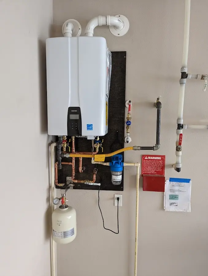 Professional plumber installing copper piping in a Chamberlayne home